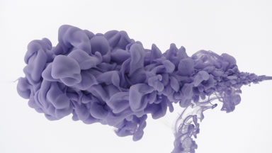 Macro shot of violet ink is being injected in water flows back