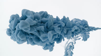 Macro shot of blue ink is being injected in water flows back