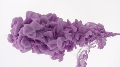 Macro shot of purple ink is being injected in water flows back