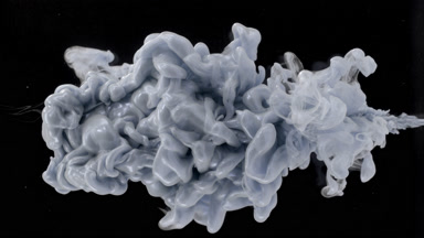 Macro shot of silver ink is being injected in water flows back