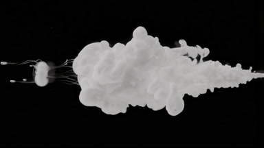 Macro of white ink is injected in water on black background