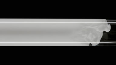 Macro of white ink flows inside test tube with water filling it