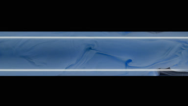 Macro shot of blue ink inside test tube with water filling it