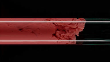 Macro of red ink flows inside test tube with water filling it