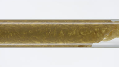 Gold ink flows inside test tube with water on white background
