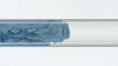 Blue ink fills glass test tube with water on white background