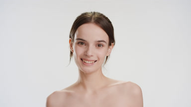 Slim Caucasian woman turns her head to the camera smiling widely