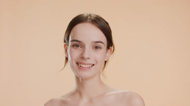 Pretty young Caucasian woman turns head to camera smiling widely