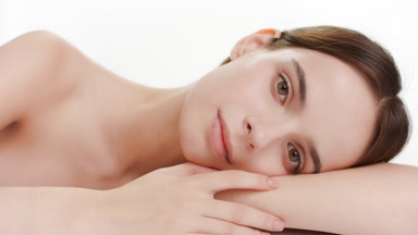 Good-looking young Caucasian woman puts head on bent arm smiling