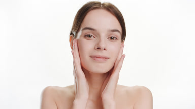 Woman touches cheeks stretching facial skin and smiling widely