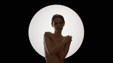 Woman strokes arms and shoulders with hands crossed on chest