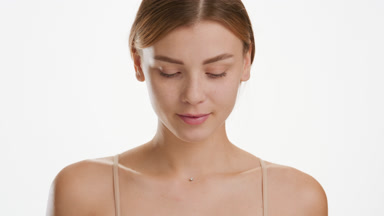 Gorgeous Caucasian woman moves head and looks at camera smiling