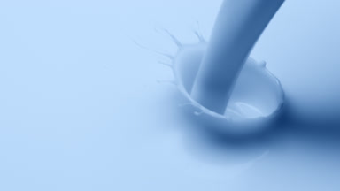 Macro shot of pale blue liquid is poured and dripped splashing