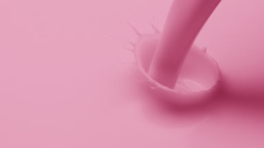 Macro shot of pale pink liquid is poured and dripped splashing