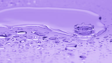 Two water drops drip on big one splashing on violet background