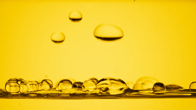 Bubbles float to surface bouncing off it on yellow background