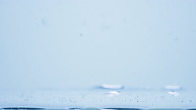 Different sized bubbles go down to surface on blue background
