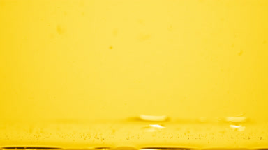Different sized bubbles go down to surface on yellow background