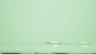 Different sized bubbles go down to surface on green background