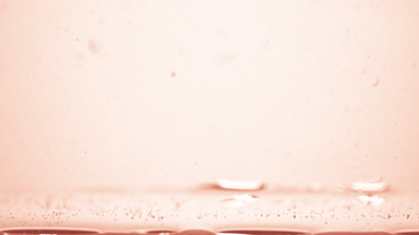 Different sized bubbles go down to surface on beige background