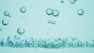 Bubbles of hyaluronic acid go down to another on cyan background