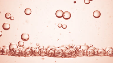 Grapefruit extract bubbles sink to another on beige background