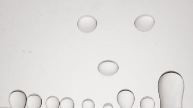 Macro of grey clear bubbles form and float on grey background