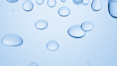 Blue transparent bubbles form and fall down on blue background