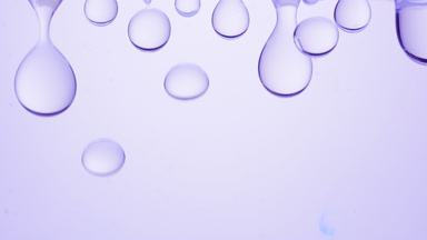 Violet transparent bubbles form and fall on violet background