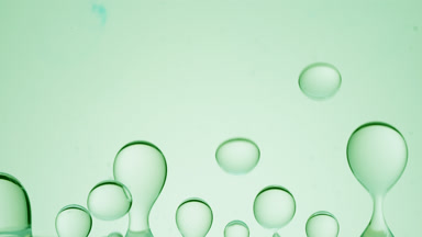 Green transparent bubbles form and float on green background