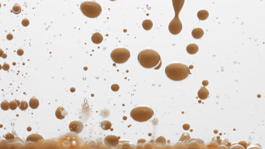 Macro of beige opaque bubbles sink on grey background