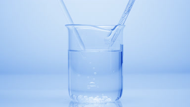 Dropper drips liquid which sink in beaker on blue background