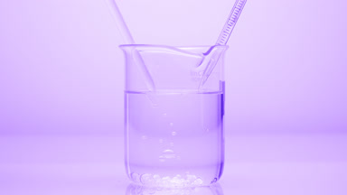 Dropper drips liquid which sink in beaker on violet background