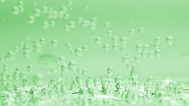 Bubbles sink to liquid surface with another on green background