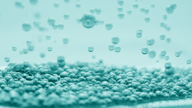 Cyan transparent bubbles sink to another ones on cyan background