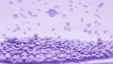 Violet transparent bubbles sink to another on violet background
