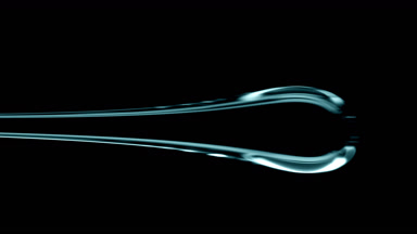 Macro of drop of cyan viscous liquid flowing on black background