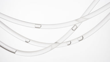Grey fluid is flowing in three connecting tubes slowing down