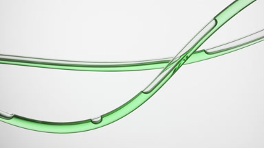 Green oil is flowing in lab connecting tubes on grey background