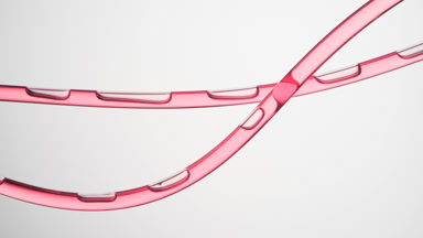 Pink oil is flowing in two connecting tubes on grey background