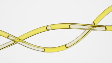 Yellow oil flows in twisted connecting tubes on grey background