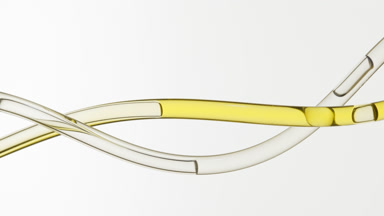 Yellow oil and colorless fluid flowing in two connecting tubes
