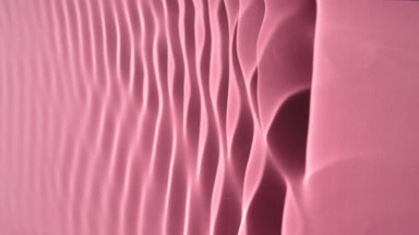 Macro shot of rippling water on pink background