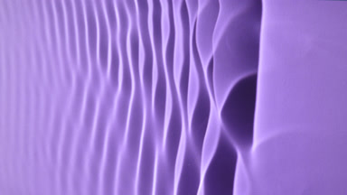 Macro shot of rippling water on purple background