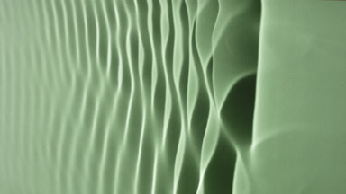 Macro shot of rippling water on green background