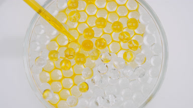 Yellow oil drained in Petri dish with octagons sinking in it