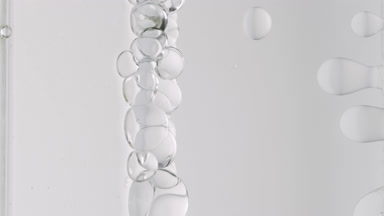 Grey transparent bubbles form and float to another ones