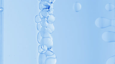 Blue transparent bubbles form and float to another ones
