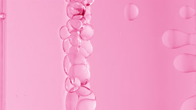 Pink transparent bubbles form and float to another ones