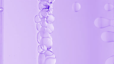 Violet transparent bubbles form and float to another ones